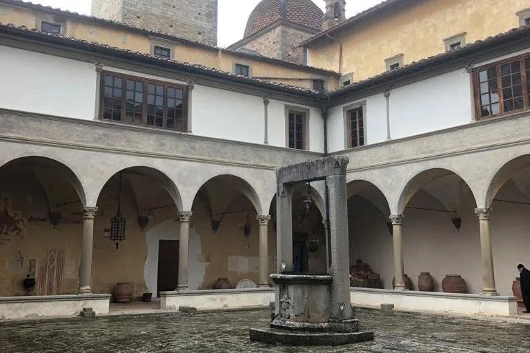 A Renaissance cloister with arches around a well